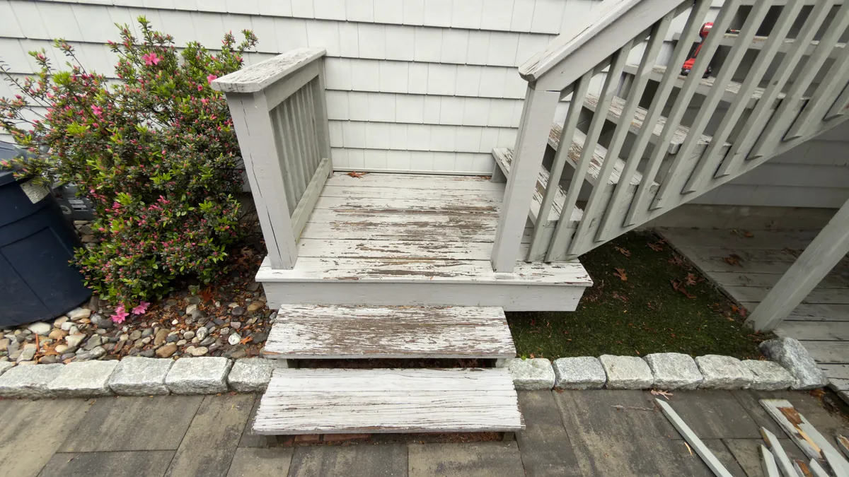 Before: peeling painted wood deck steps at a paver landing in Stratford, CT