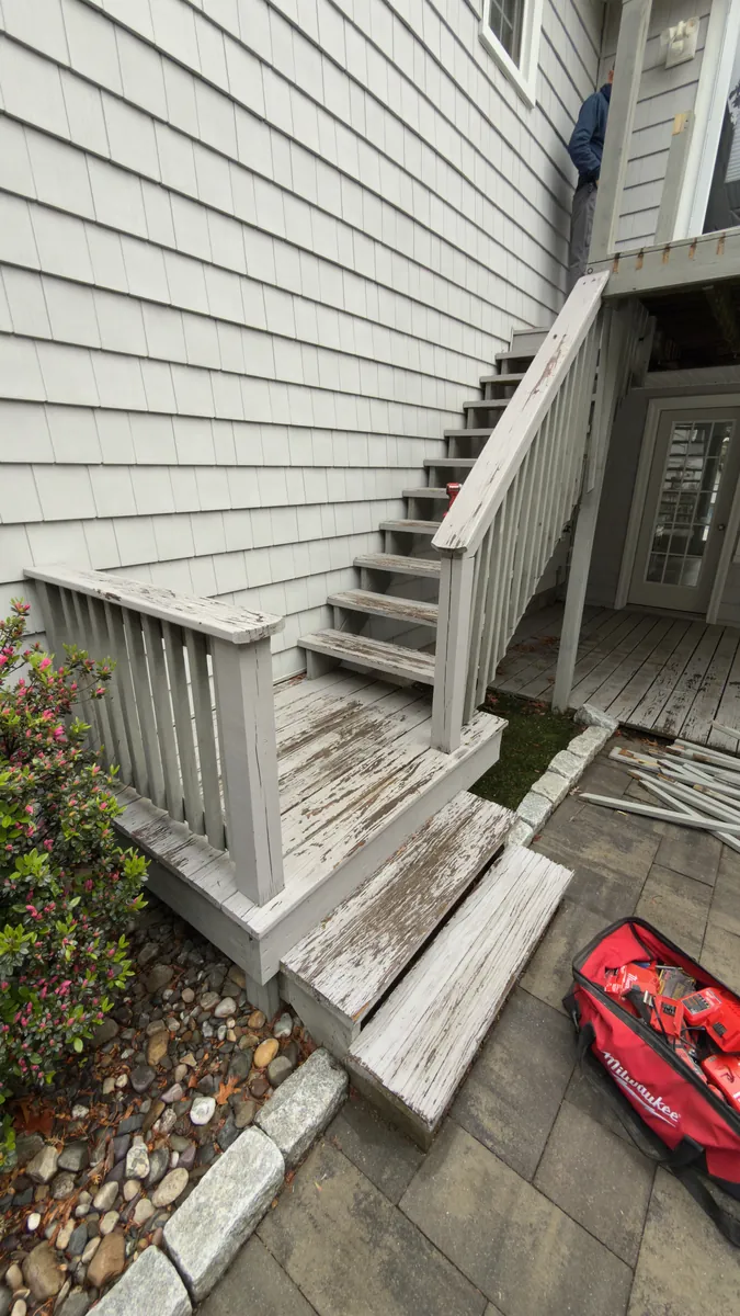 Before: worn wood stairs and railing at the side of the house in Stratford, CT