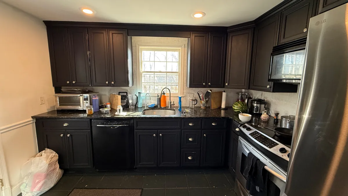 Before: black cabinets, granite counters and a slate tile floor in Westport, CT