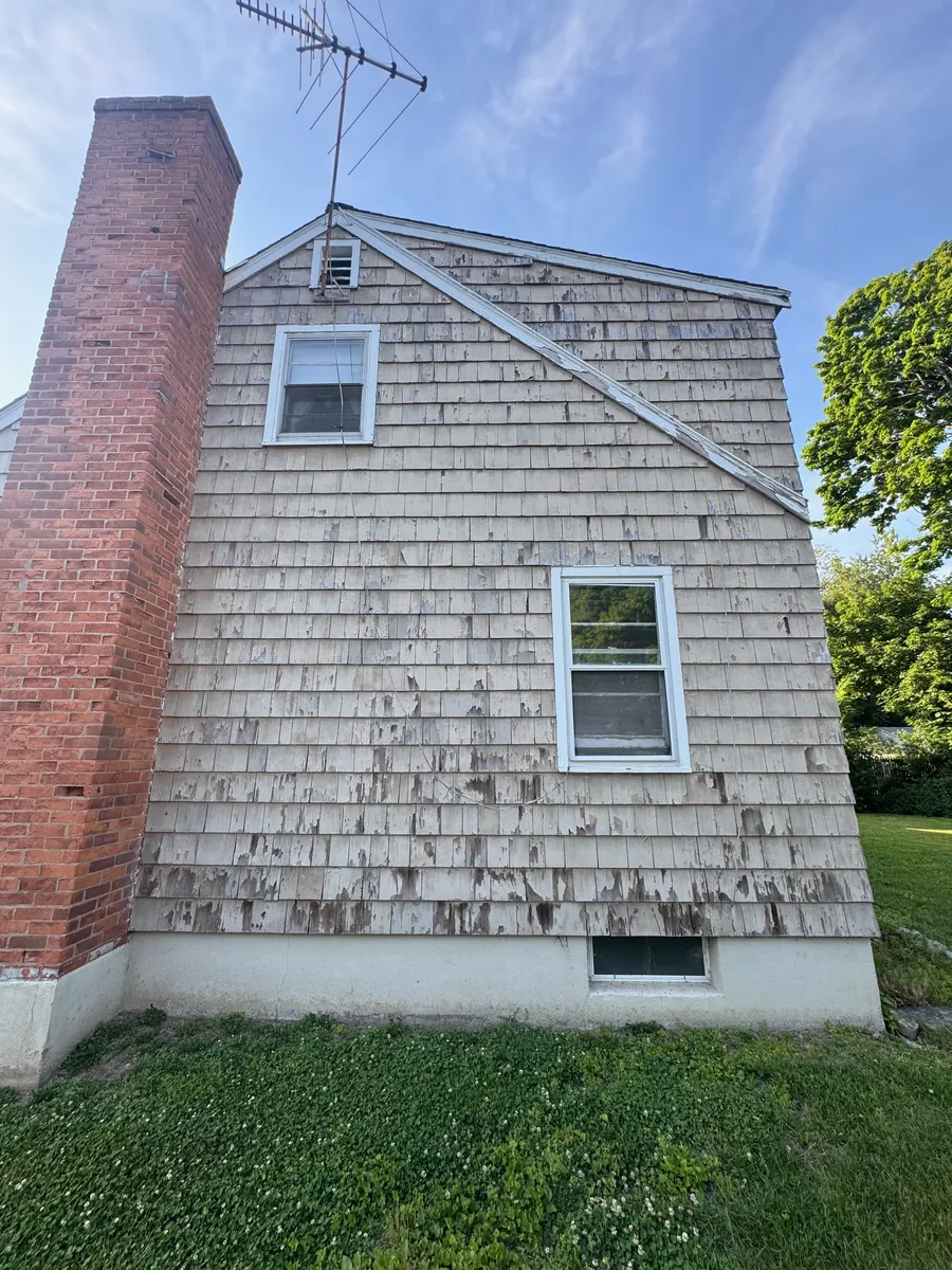 Before: faded shingle siding at the rear corner by the chimney in Stratford, CT